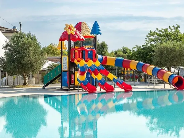 The colourful children's slide at the children's pool at Vigna sul Mar campsite.