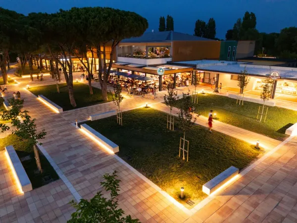 Attractive walking area with restaurant at Roan camping Pra'delle Torri.