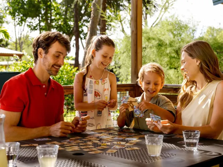 A family is playing a game at Roan Camping Village Bella Iseo.