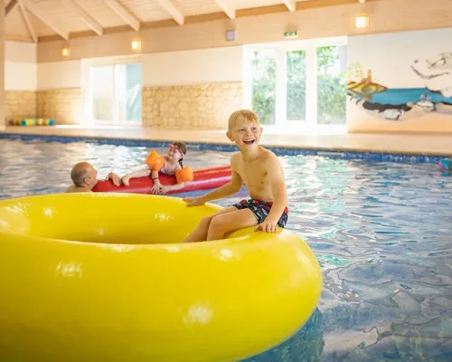 Child plays in swimming band at Roan campsite Marvilla Parks Friese Meren.