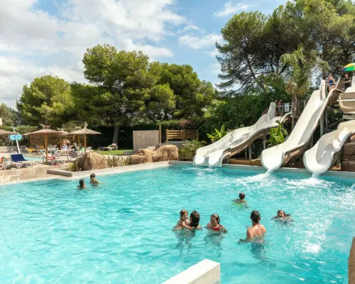 Swimming pool with slides at Roan camping El Garrofer.