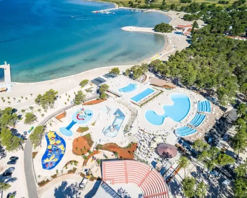 Overview of the swimming pool and beautiful bay at Roan campsite Zaton Holiday resort.