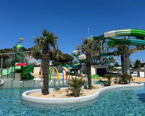 Renewed swimming pool with cool slides and water playground at Le Domaine du Clarys campsite.