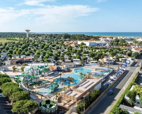 The swimming pool with cool slides and a water play area at Le Domaine du Clarys campsite.