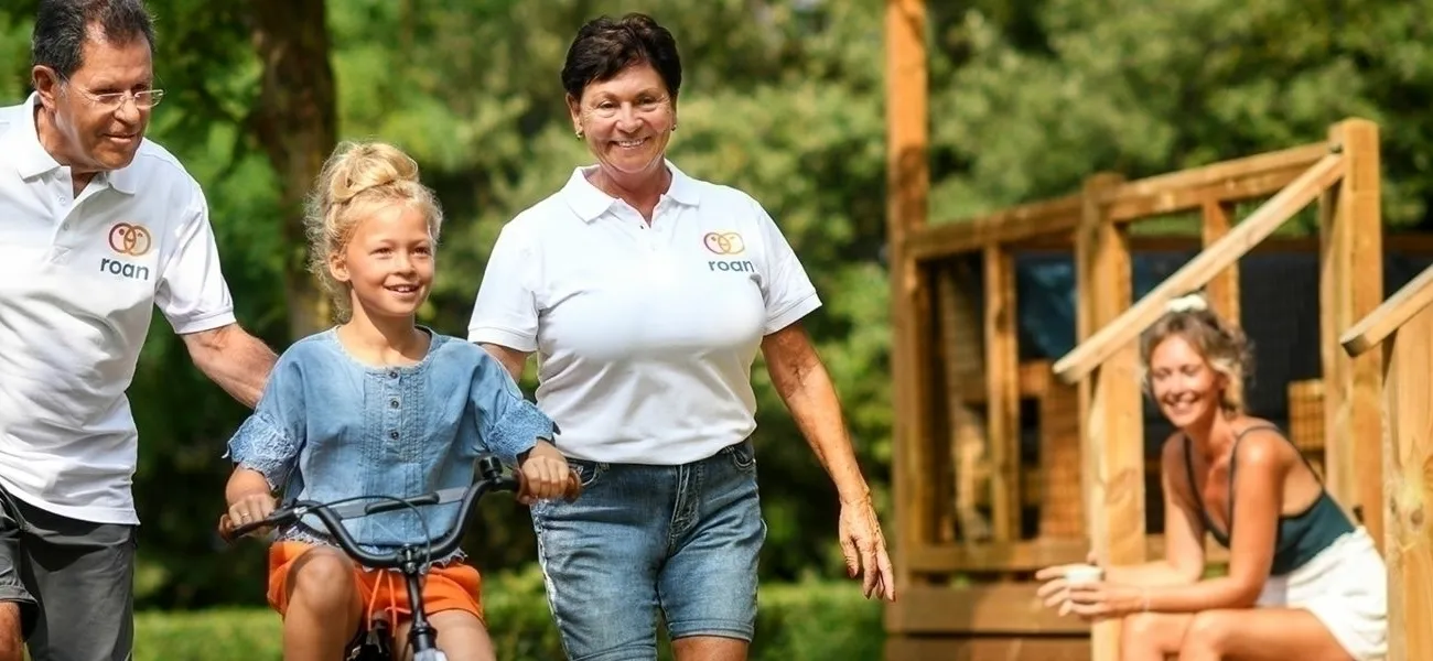 Roan camping staff and guests with children's bikes.