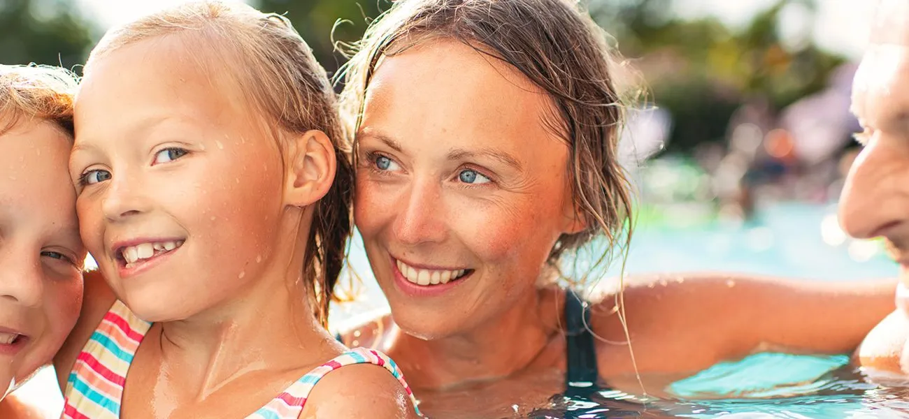 Family enjoying the pool at a Roan campsite.