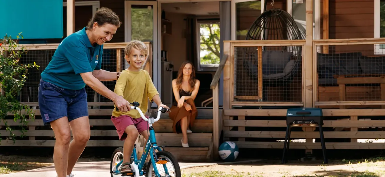 Roan camping staff and guests with children's bikes.